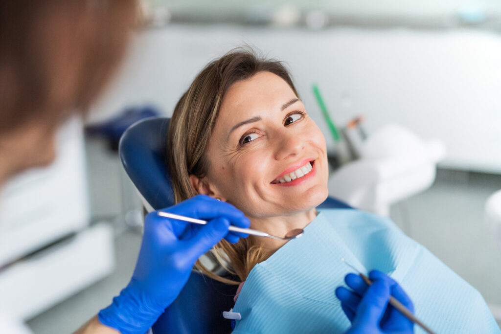 A woman has a dental check-up in dentist surgery.