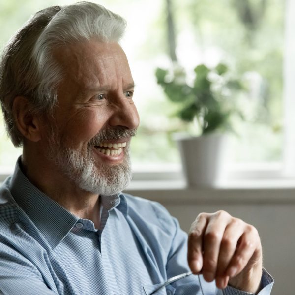 Happy older male smiling with perfect teeth